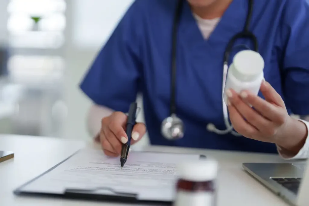 Adult medical professional reviewing prescription medication doc