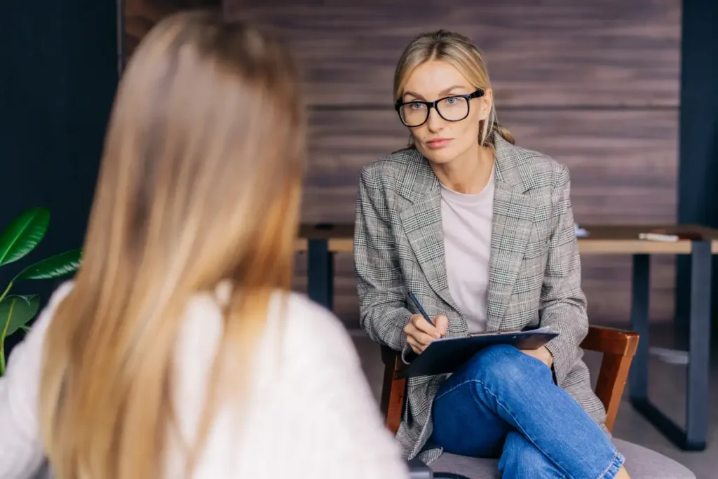 Female Therapist Listens to the Patient