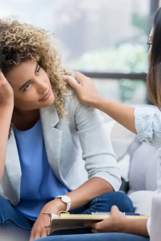 Upset woman talks with mental health professional