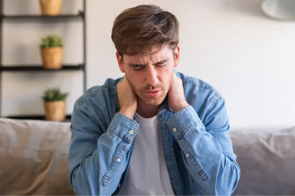 A young man suffering from muscle pain