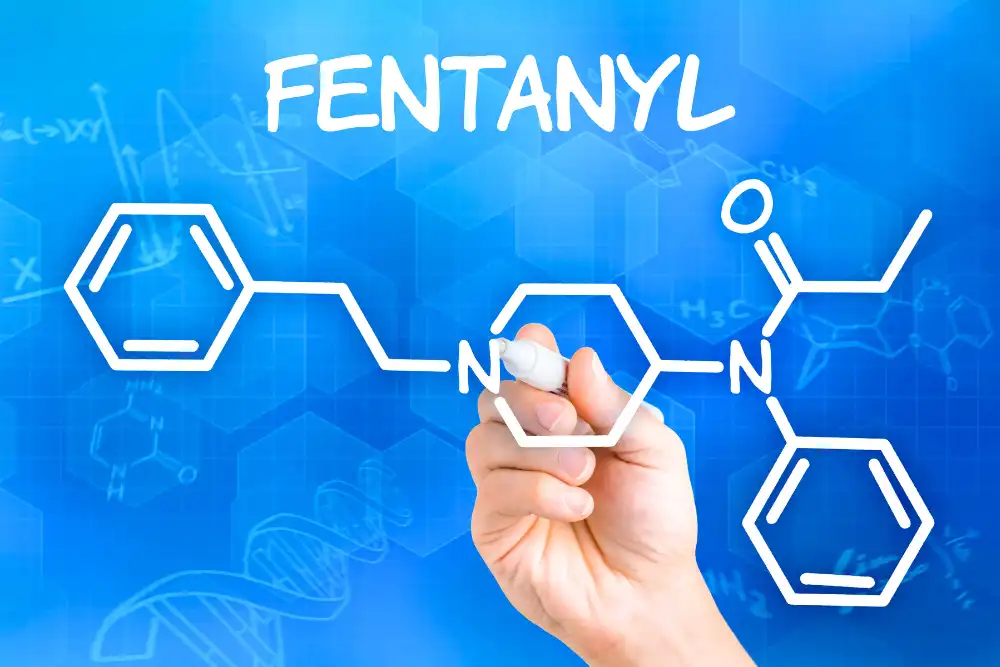 Hand with pen drawing the chemical formula of fentanyl
