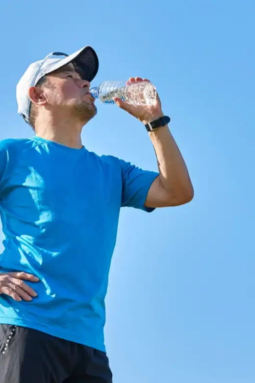 Man Hydrating During Outdoor Exercise