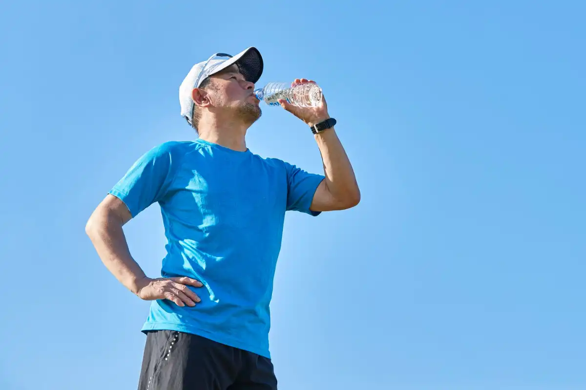 Man Hydrating During Outdoor Exercise