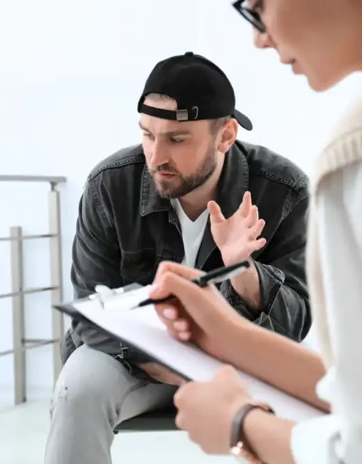 Psychotherapist working with a man in addiction treatment center