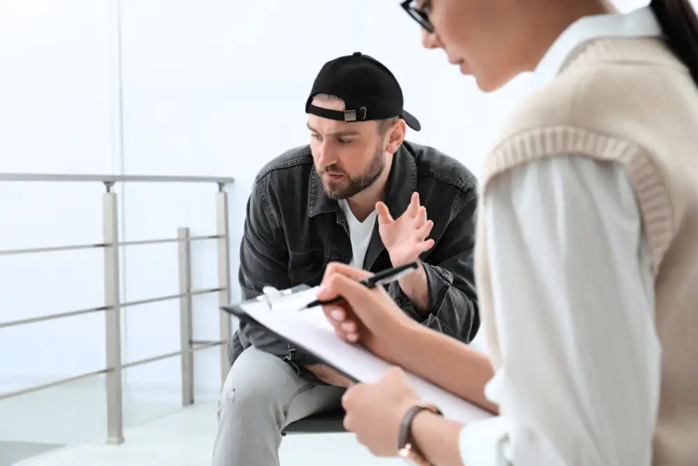 Psychotherapist working with a man in addiction treatment center