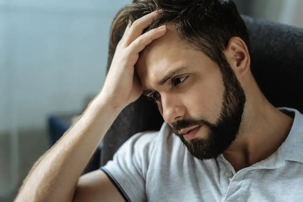 Sad bearded man feeling frustrated after a relapse