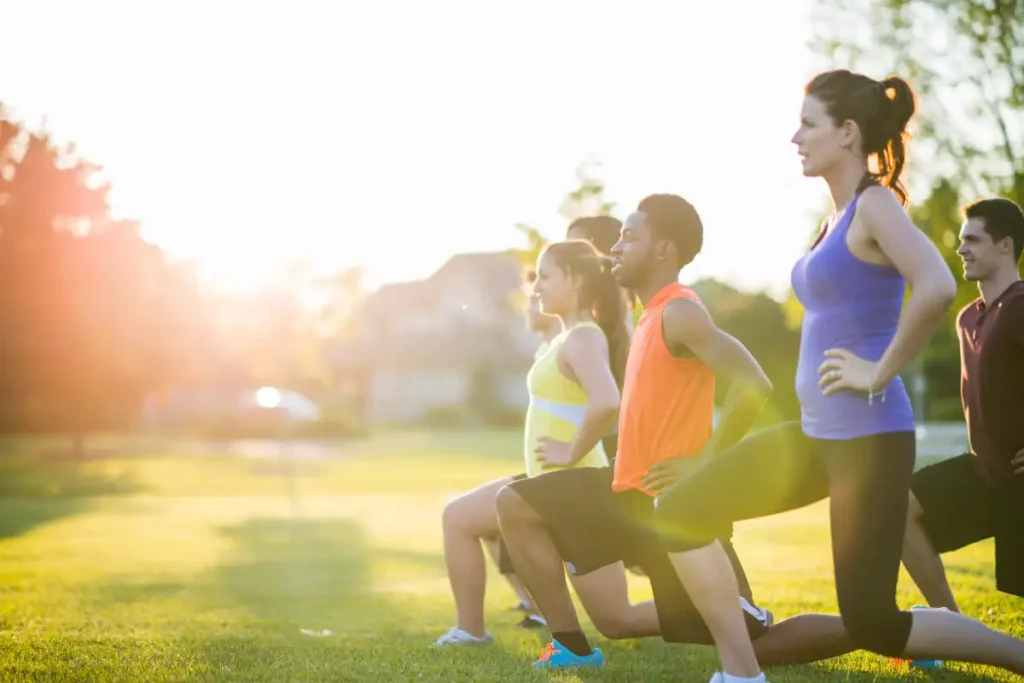 men and women doing some exercise in the park addiction recovery riverside california