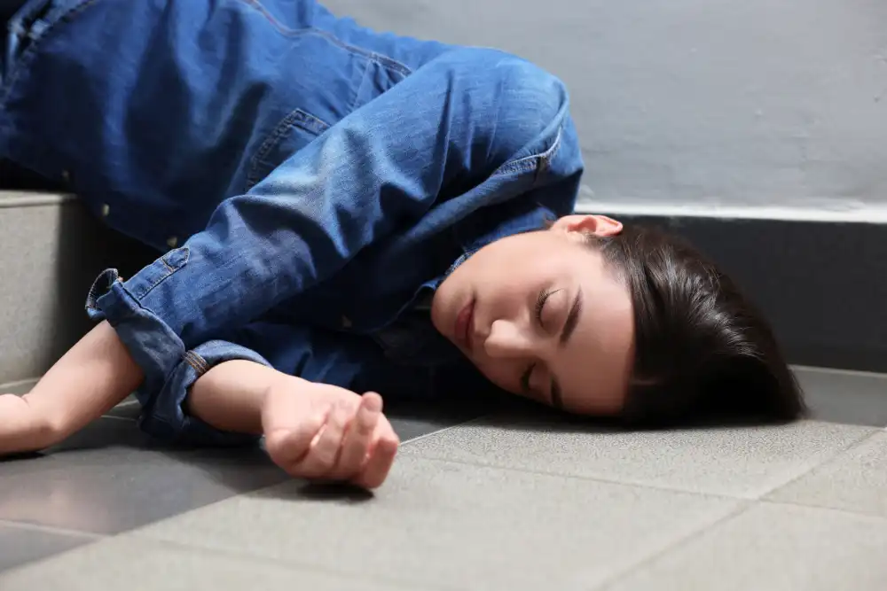 unconscious woman lying on floor