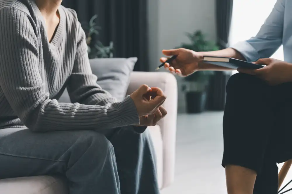 young woman with clenched hands during mental health counseling