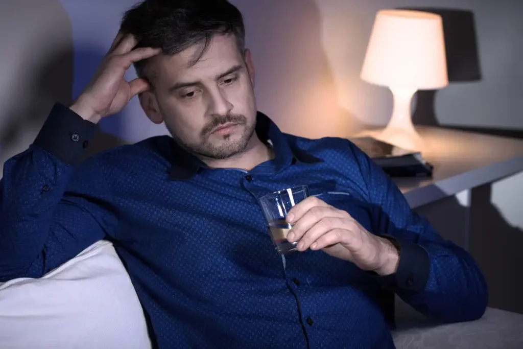 Miserable man drinking alcohol