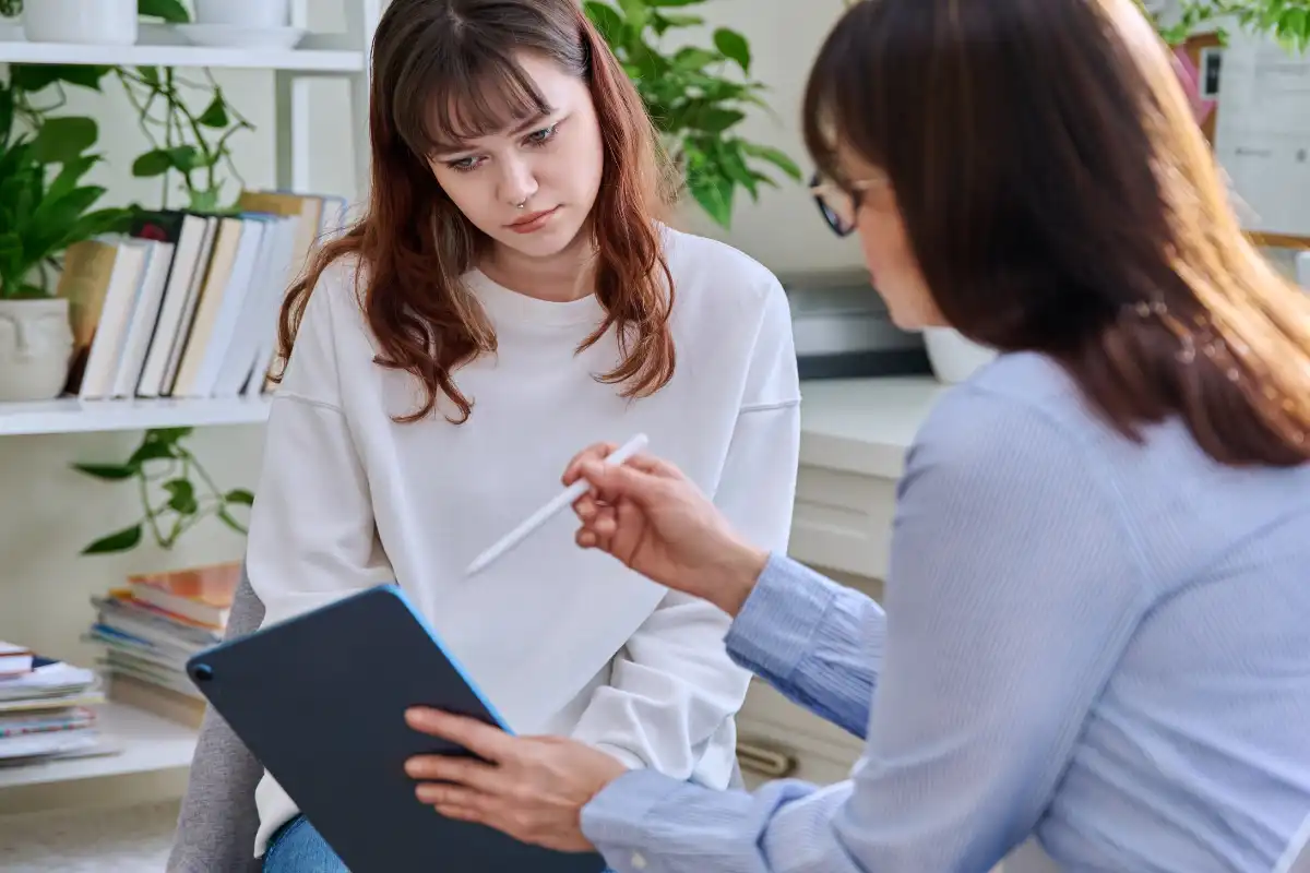 Teenage girl at session with mental health professional
