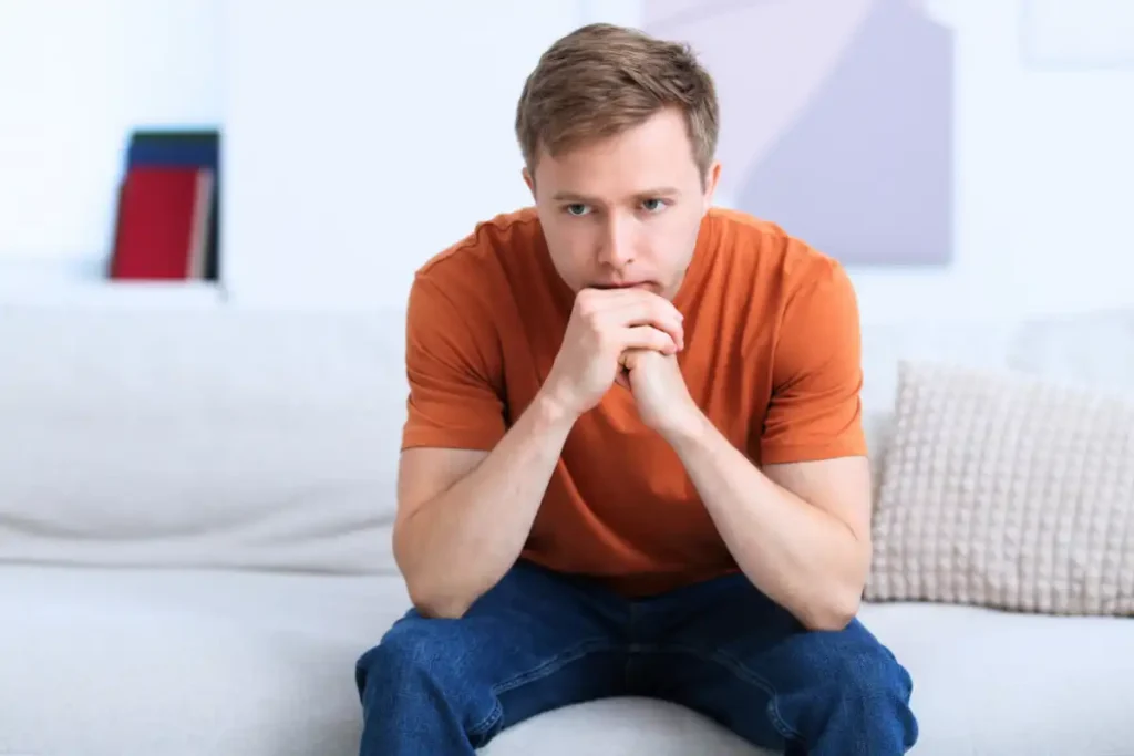 Thoughtful Man on Sofa at Home