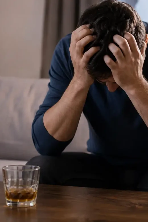 Distressed Man Beside Amber Drinks