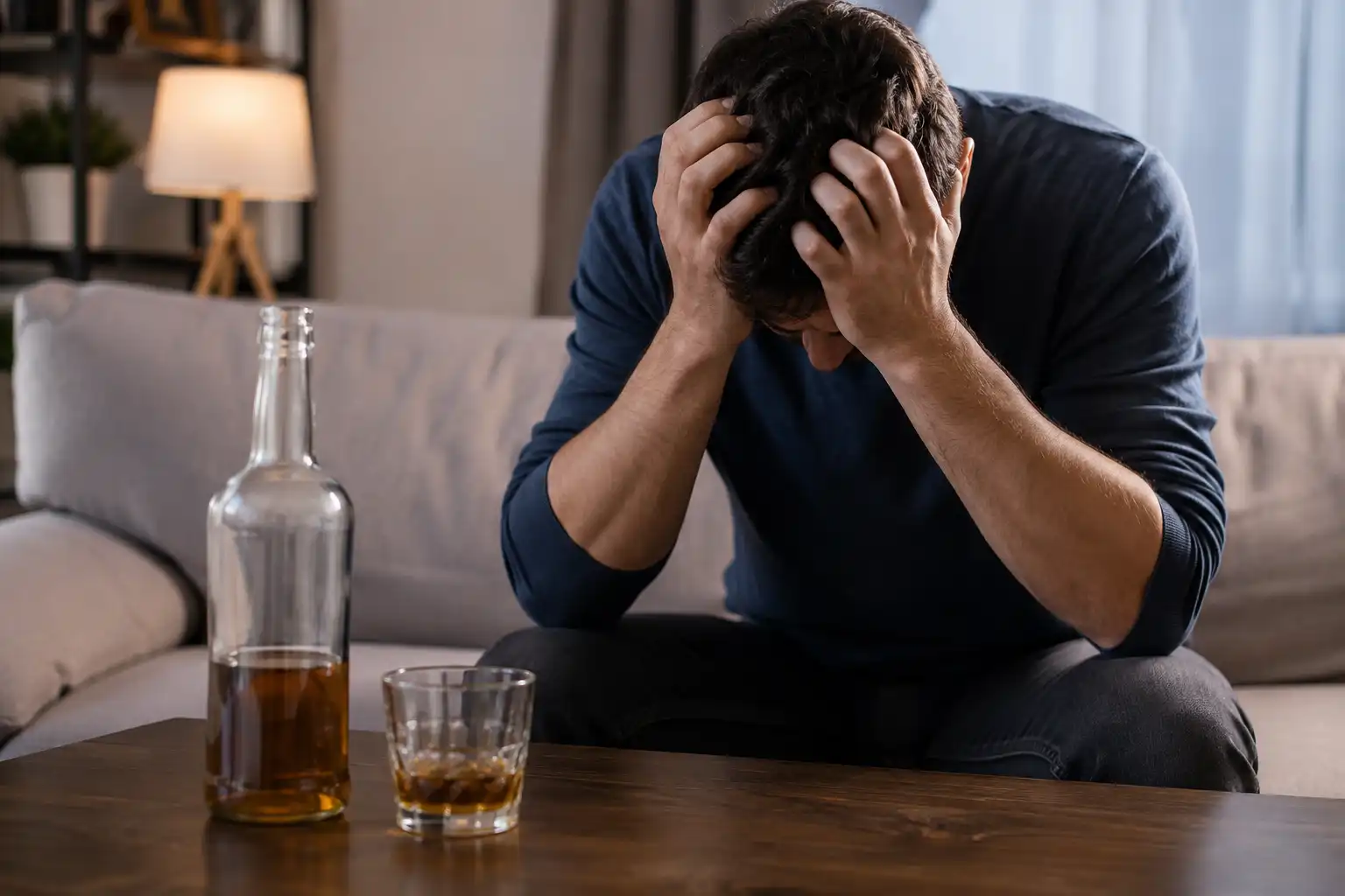 Distressed Man Beside Amber Drinks